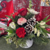 A bouquet of red and white mixed with pinecones that is sure