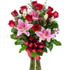 Bouquet of red roses and pink lilies in a glass vase with a red ribbon