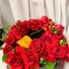 A generous display of red roses and Champagne arranged in a wooden