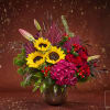 Bouquet of sunflowers, red roses, and pink hydrangea in a dark vase