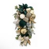 Holiday wall swag with gold ornaments, ribbon, and evergreen accents