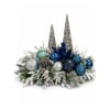 Holiday centerpiece with blue ornaments and silver cone accents