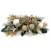 Holiday centerpiece with gold ornaments, pinecones, and greenery