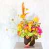 A cheerful orange, fuchsia, yellow green color palette vase arrangement create with