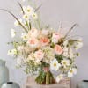Blush roses and white cosmos in a loose bouquet with airy filler flowers