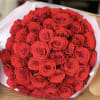 Large bouquet of red roses wrapped in white paper