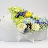 White hatbox arrangement with pastel roses, hydrangeas, and filler flowers