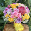 Bouquet of pink and yellow roses in a yellow rain boot vase