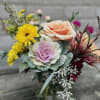 A beautifully designed interesting, fall arrangement, perfect for a desk small table