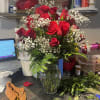 Bouquet of red roses and baby's breath in a glass vase