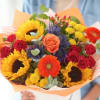 Mixed bouquet with sunflowers, roses, and gerbera daisies in orange wrap