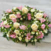 Oval floral wreath with cream roses and pink blooms