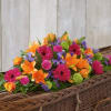 Bright mixed flower arrangement in a wicker basket