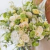 Bouquet of cream roses and white flowers with green accents