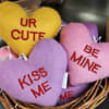 Heart-shaped plush gifts in a wicker basket with embroidered messages