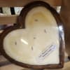 Heart-shaped candle in a wooden container