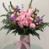 Pink rose bouquet in a silver vase with a pink ribbon