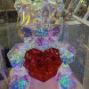 Iridescent geometric teddy bear holding a red heart
