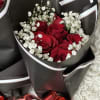 Bouquet of red roses with white baby's breath in black wrapping