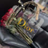 Bouquet of red roses in a clear gift bag with a decorative handle