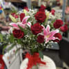 Bouquet of red roses and pink lilies in a glass vase