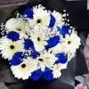 Bouquet of white gerbera daisies and blue roses wrapped in black paper