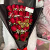 Bouquet of red roses in black wrap with a red ribbon