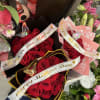 Bouquets of red roses with Mother's Day ribbons and butterfly decorations
