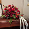 Rich tones of red roses and gladioluses, highlighted with stargazer lilies and