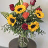 Bouquet of sunflowers and roses in a glass vase
