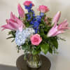 This delightful arrangement has hydrangea, lily&rsquo;s, roses and delphinium. 
