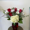 This romantic one-sided arrangement comes in a red glass vase and features