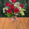 6 red roses with baby's breath and greens in a an 8