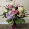 A beautiful arrangement with white lilies , alstromeria, white and pink roses