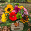 Colorful mixed bouquet with sunflowers, gerbera daisies, and mums outdoors