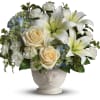 White lilies and cream roses in a decorative vase