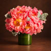 Pink peony bouquet in a green glass vase