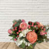 Bouquet of coral roses, pink tulips, and white hydrangeas in a vase