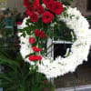 Red and white funeral standing spray on an easel