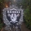 Raiders memorial wreath with silver flowers and ribbon