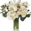 A design masterpiece of white blooms with a touch of greens beautifully