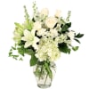 White roses and lilies arranged in a clear glass vase