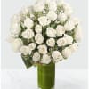 White roses arranged in a tall green glass vase