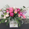 Pink and lavender rose bouquet in a white wooden box