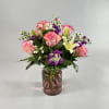 Pink roses and white lilies in a glass vase
