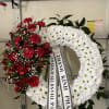 Red and white funeral wreaths with ribbon streamers