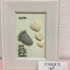Framed keepsake with baby footprints and heart shapes