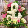Pink roses and white floral arrangement in a basket