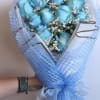 Bouquet of blue roses with white baby's breath in blue mesh wrap