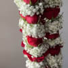 Hanging arrangement of red roses and white baby's breath